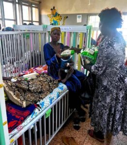 Director giving items to the patients